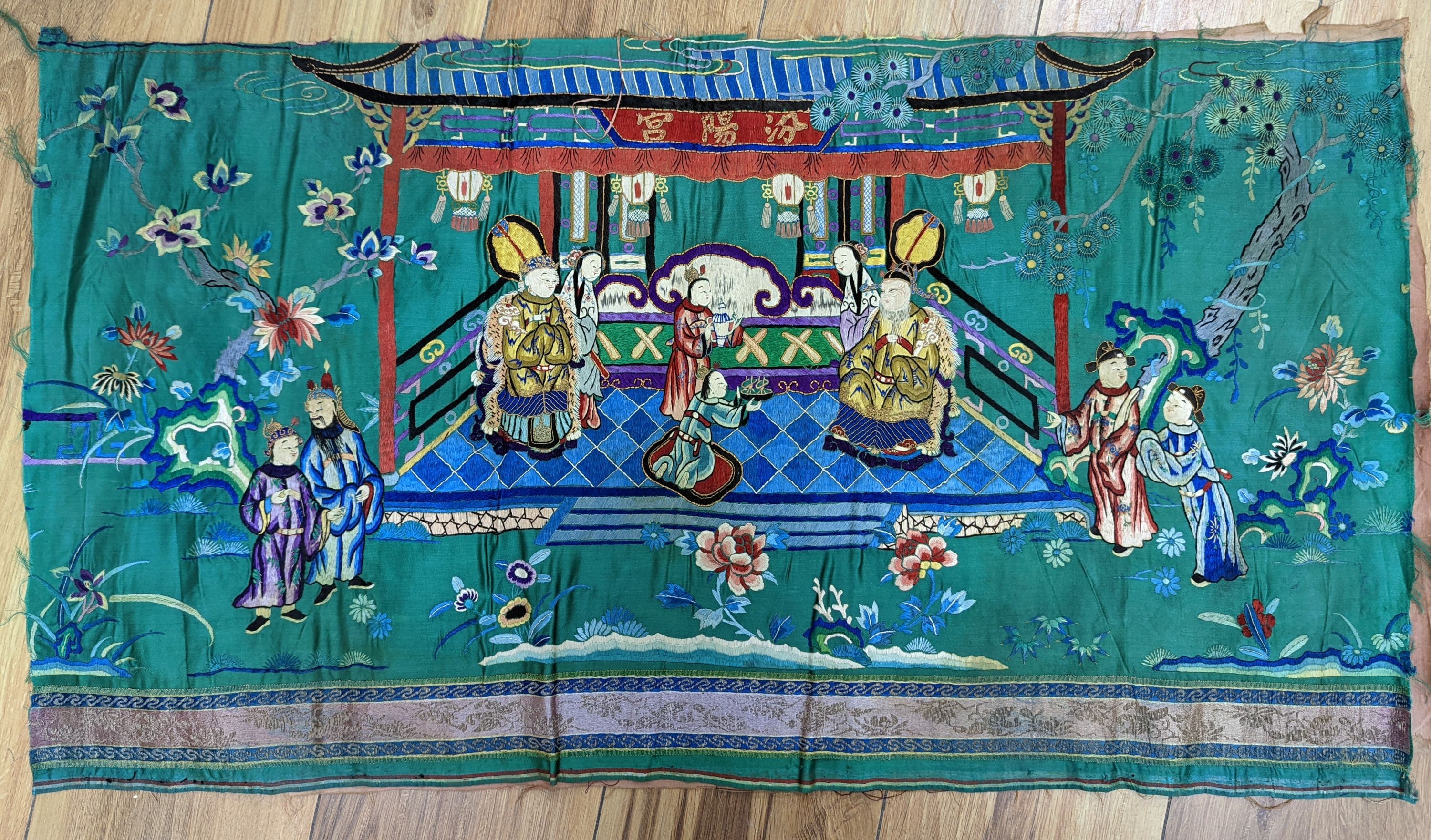 An early 20th century Chinese silk figurative embroidery from a larger panel of an emperor and empress scene.